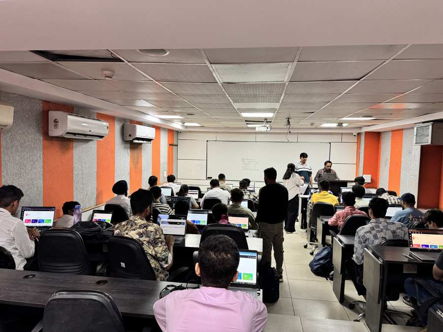 Students attending a Coding Blocks classroom session with laptops